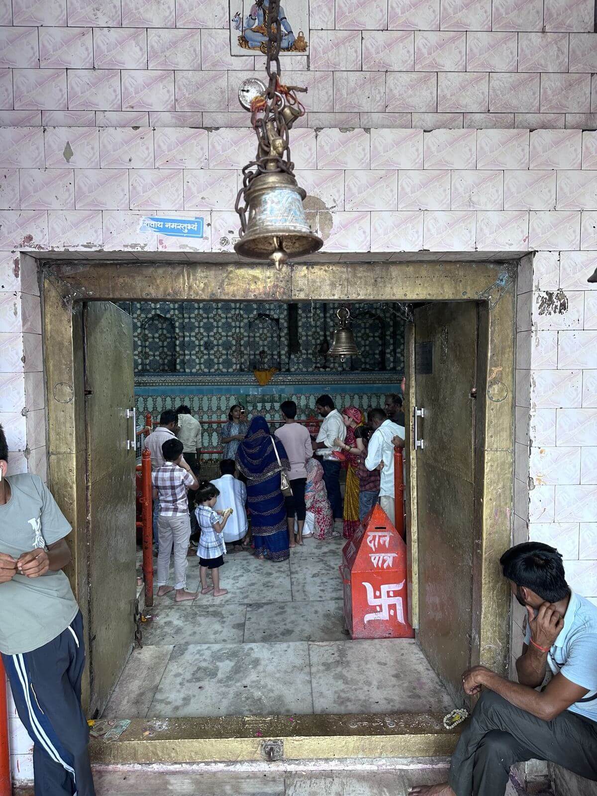 Brass bell above the open doorway into the sanctum